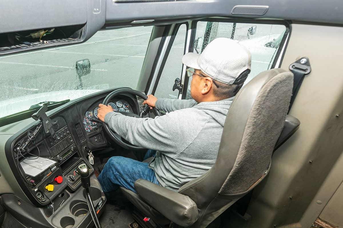 A 火博体育 student in the cab of a large commercial truck